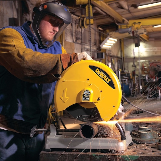 Chop Saw with QUIK-CHANGE™ Keyless Blade Change System being used by a person to cut metal pipe