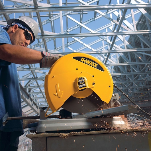 Chop Saw with QUIK-CHANGE™ Keyless Blade Change System being used by a person to cut metal rod
