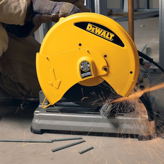 Chop Saw with QUIK-CHANGE™ Keyless Blade Change System being used to cut metal rods