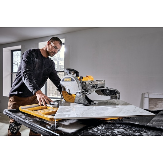 High Capacity Wet Tile Saw being used by a construction worker to cut tile diagonally
