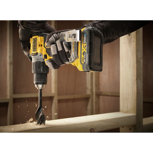 The 3.5Ah Powerstack battery on Drill Driver being used to drill timber frame