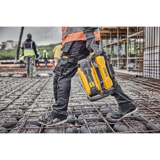Powershift 554WH battery being carried onto a construction site