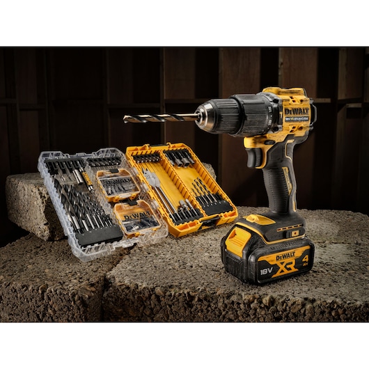 The limited edition 18V Brushless 100 year Hammer Drill Driver sitting next to open DT70784 100 piece drill drive kit