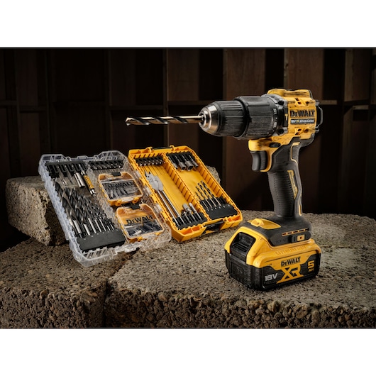 The limited edition 18V Brushless 100 year Hammer Drill Driver sitting next to open DT70784 100 piece drill drive kit