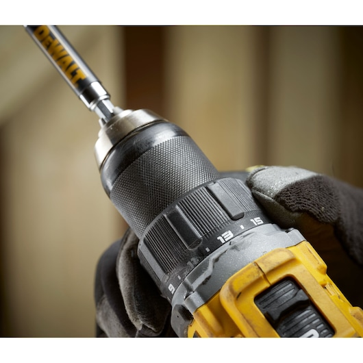 Close up of worker changing settings on the the 18V XR Brushless Compact Hammer Drill Driver 