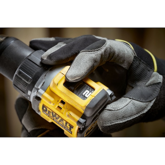 Worker changing settings on the the 18V XR Brushless Compact Hammer Drill Driver 
