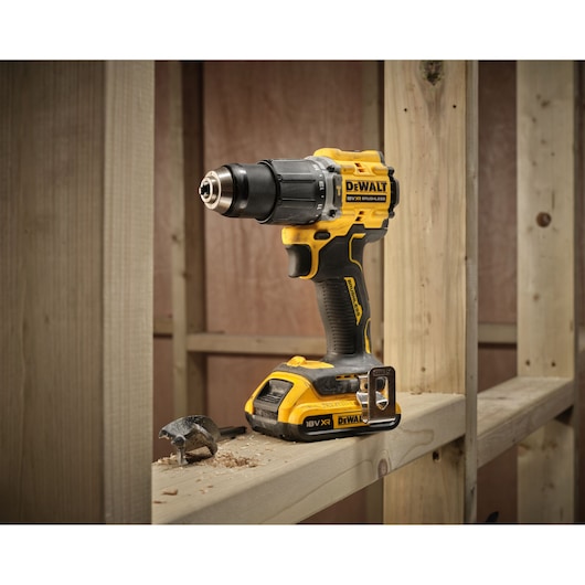 18V XR Brushless Compact Hammer Drill Driver with 18V 2Ah battery 3/4 view sitting on wooden frame