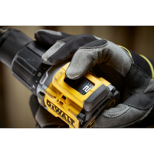 Worker changing settings on the the 18V XR Brushless Compact Hammer Drill Driver 