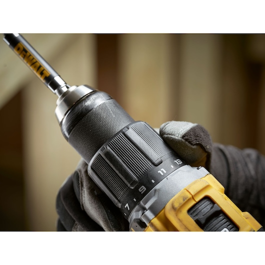 Close up of worker changing settings on the the 18V XR Brushless Compact Hammer Drill Driver 