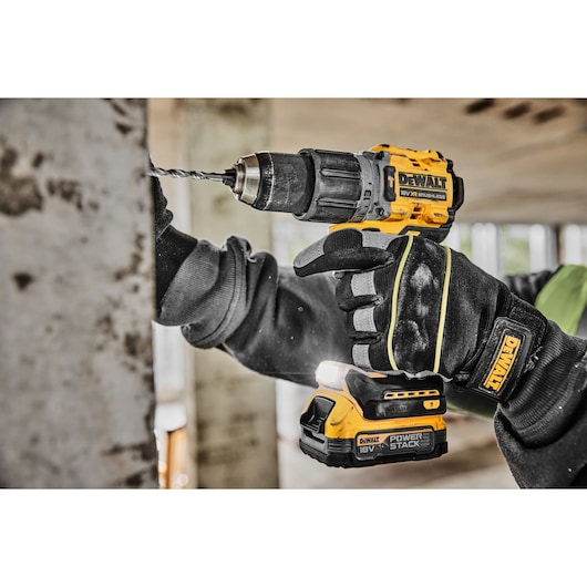Close view of DCD805E2T 18V XR Brushless Hammer Drill drilling into a wall