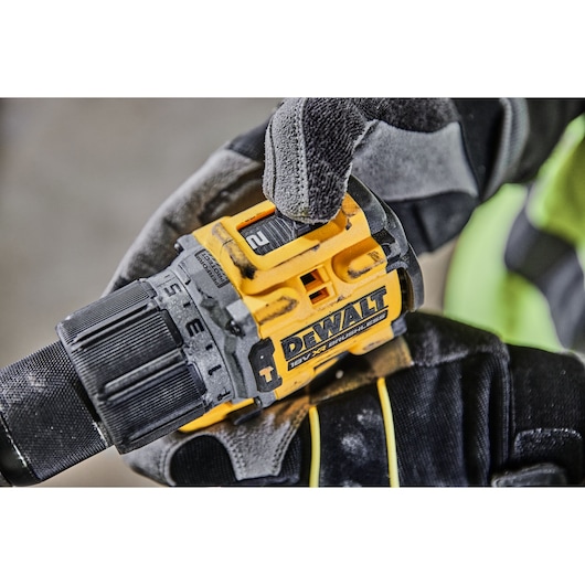 A gloved hand adjusting the speed setting on a DCD805H2T 18V XR Brushless Hammer Drill
