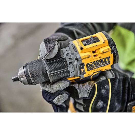 A gloved hand adjusting the speed setting on a DCD805H2T 18V XR Brushless Hammer Drill