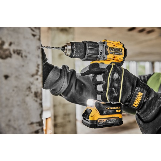 Close view of DCD805NT 18V XR Brushless Hammer Drill drilling into a wall