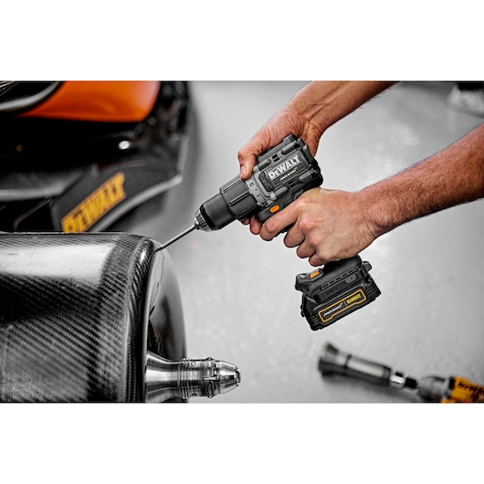 Limited Editon DEWALT/McLaren Drill Driver being used at an angle on McLaren carbon fibre wheel  