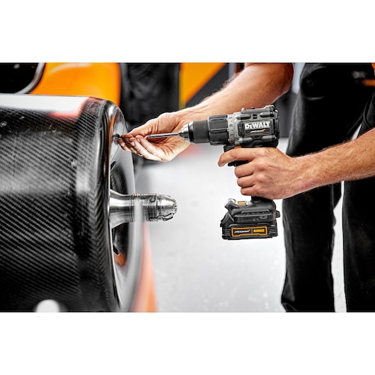 Limited Editon DEWALT/McLaren Drill Driver being offered up towards carbon fibre wheel  