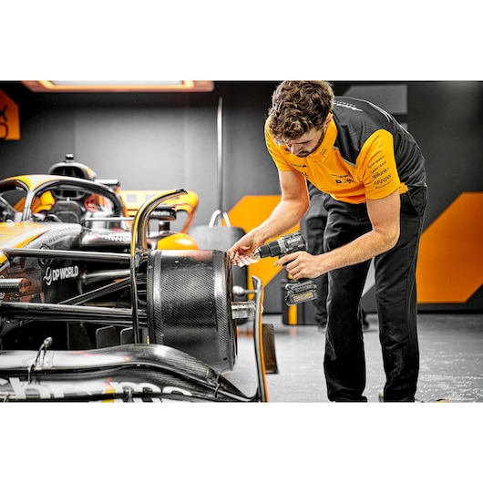 McLaren pit crew member using Limited Editon DEWALT/McLaren Drill Driver on McLaren carbon fibre wheel  