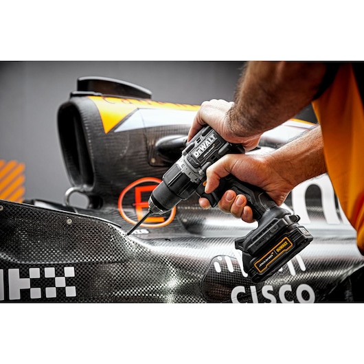 Limited Editon DEWALT/McLaren Drill Driver being used at an angle on car chassis