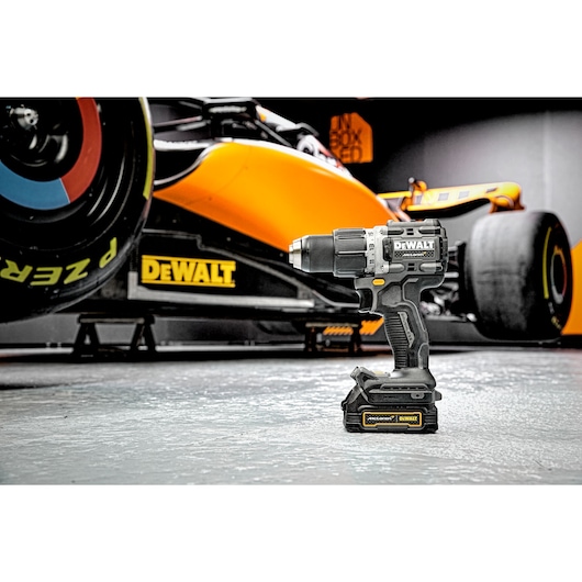 Limited Editon DEWALT/McLaren Drill Driver in foreground with McLaren F1 car in the background