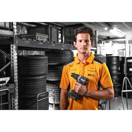 McLaren pit crew member holding Limited Editon DEWALT/McLaren Drill Driver 