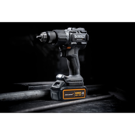 DEWALT/McLaren Drill Driver with 18V XR 4Ah battery 3/4 view in staged dark setting