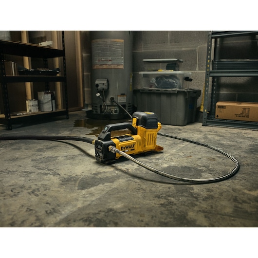 DEWALT 18V XR Transfer Pump in basement setting connected to a water heater