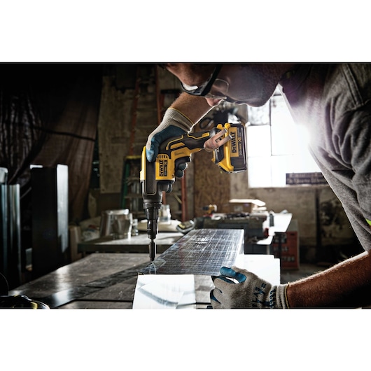 XR Versa-Clutch adjustable torque screw gun being used by person on metal surface.