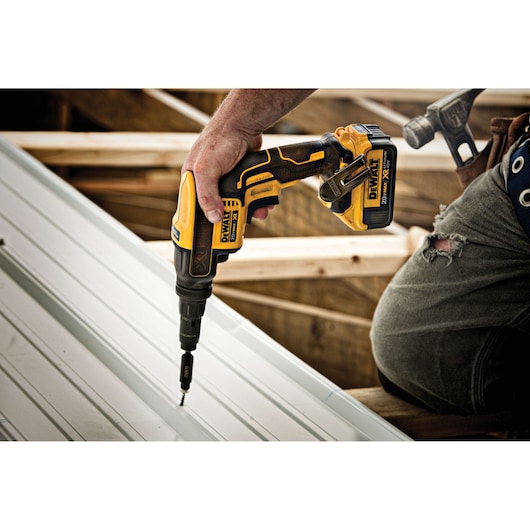 XR Versa-Clutch adjustable torque screw gun fastening screw through metal roof panel.