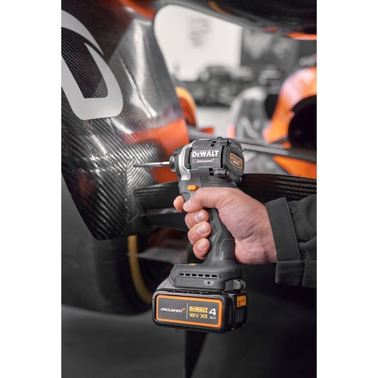 Close view of DEWALT/McLaren impact driver being used on McLaren racing car