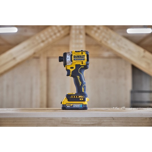 Side view of 18V XR 4 Speed Premium Impact Driver with Powerstack battery standing on wooden beam
