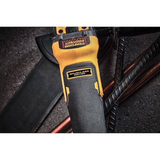 Close view of Brushless 18V XR 125mm cordless angle grinder body. Yellow and black label reads BRUSHLESS MOTOR