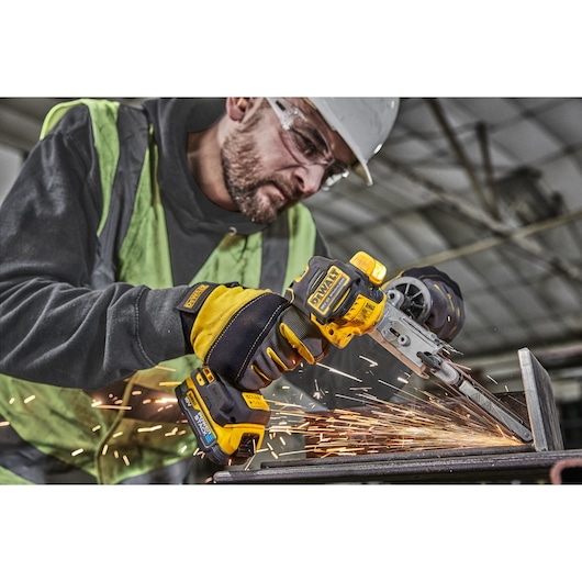 Worker using 18V XR Band File to sand metal