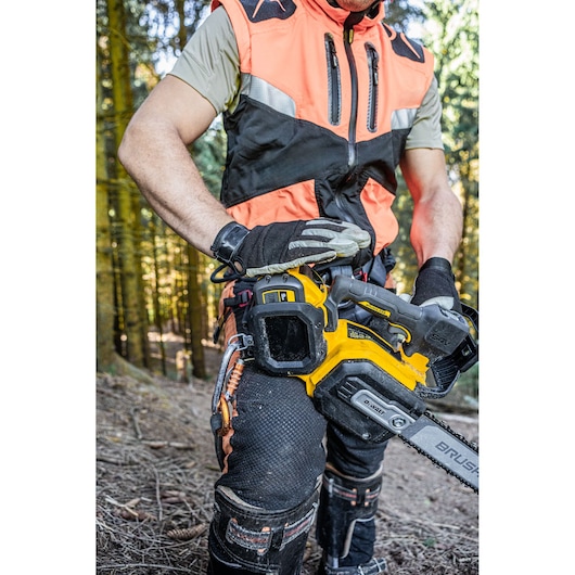 Arborist holding the DCMCST635 showing harness attachment point and D-Ring tether