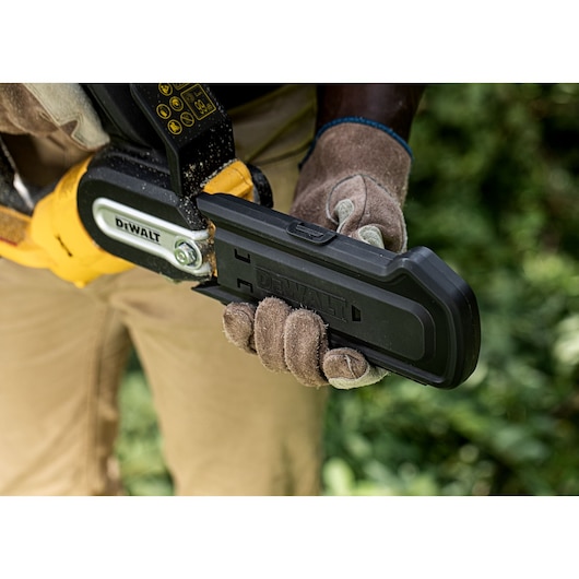 Safety guard being closed on an 18V XR Brushless Chain Saw