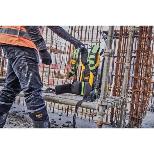 Worker picking up Powershift Backpack Concrete Vibrator