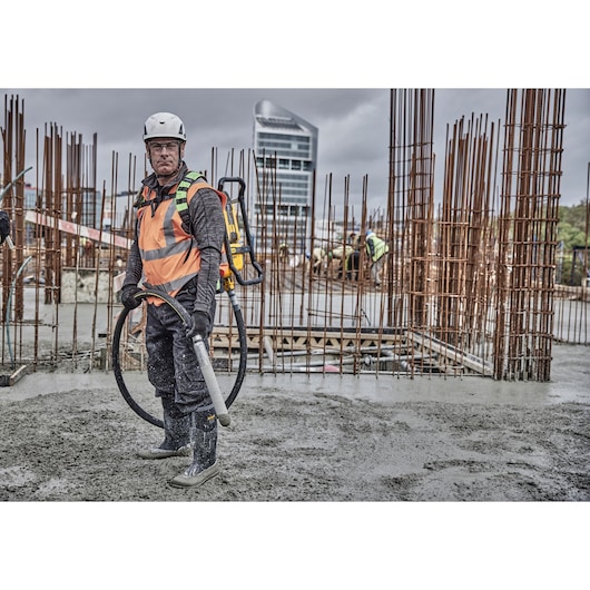 Worker preparing to pour concrete using Powershift Backpack Concrete Vibrator 