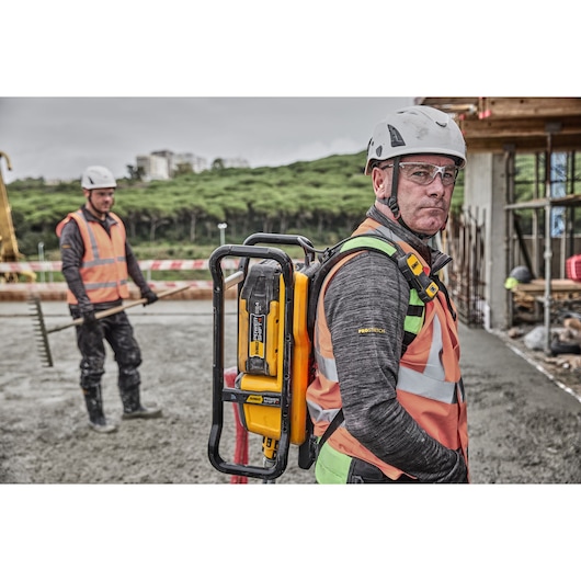 Construction worker wearing Powershift Backpack Concrete Vibrator on his back