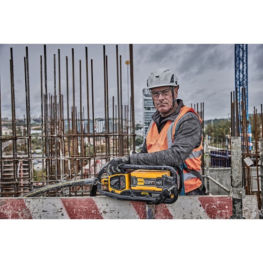 Construction worker holds Powershift Powerpack Concrete Vibrator 
