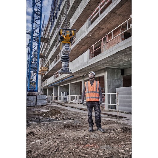 Powershift Rammer is being winched in the air by a crane on a construction site