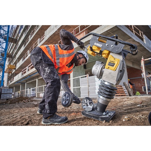 Construction worker fixing transportation wheels to Powershift Rammer