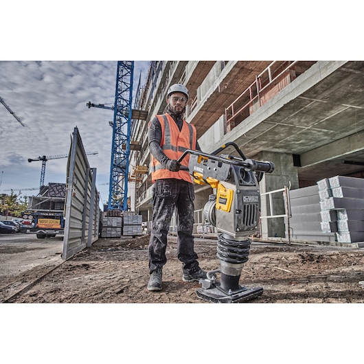 Worker preparing to use Powershift Rammer on a construction site