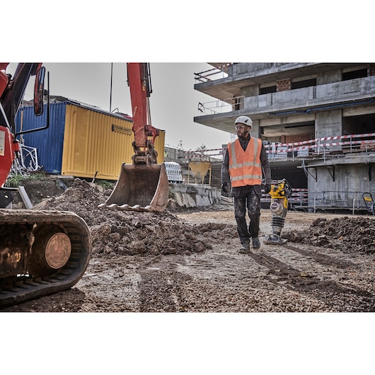 Worker walking away from a Powershift Rammer on a construction site