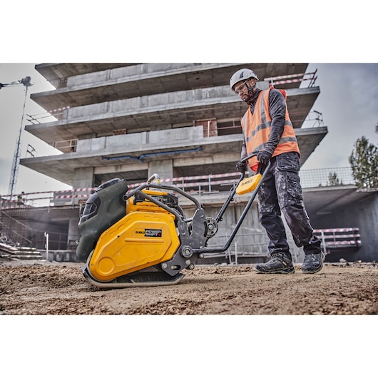 Construction worker uses Powershift Plate Compactor