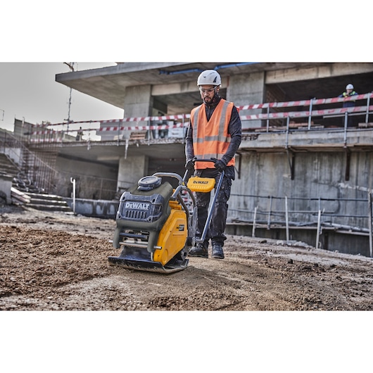 Worker uses Powershift Plate Compactor to compact the ground on a construction site