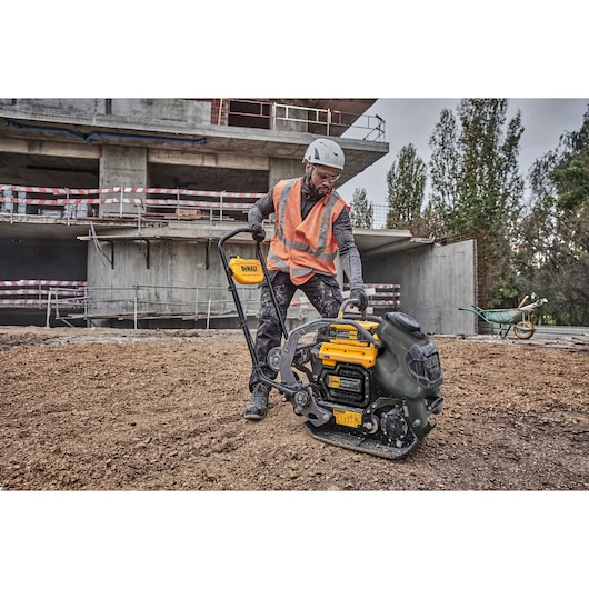 Construction worker preparing to use Powershift Plate Compactor