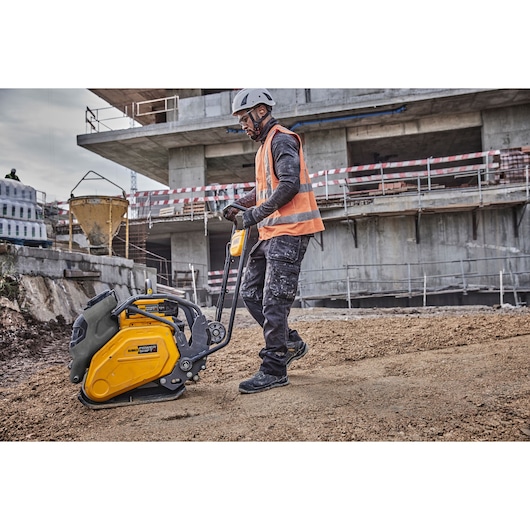 Worker uses Powershift Plate Compactor to compact the ground on a construction site