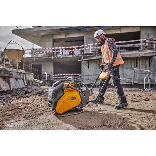 Construction worker uses Powershift Plate Compactor to compress the ground on a construction site