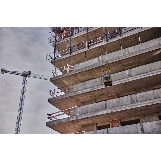Powershift Plate Compactor being winched into the air on a construction site