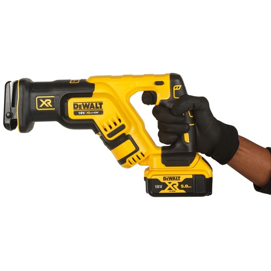 Gloved hand holding 18V XR Brushless Reciprocating Saw with 5.0Ah Powerstack battery