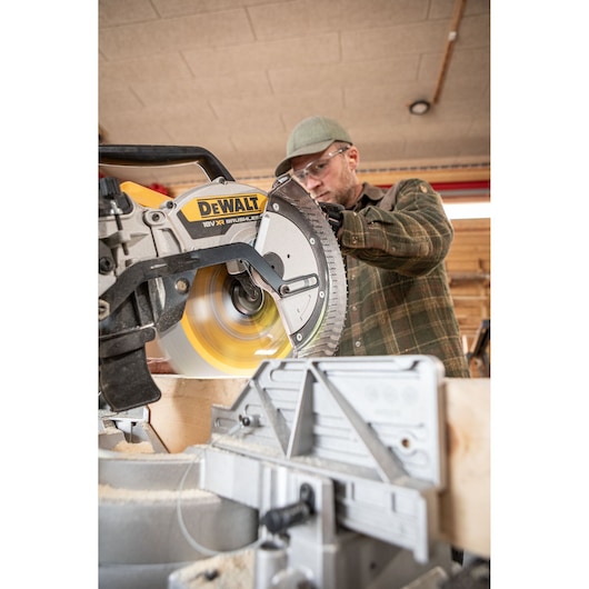 The DEWALT 18V XR 305mm Slide Mitre Saw being used by carpenter in wood shop