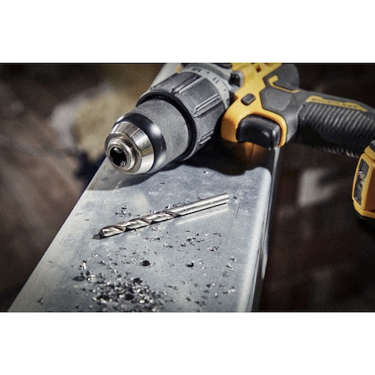 E1	Close up of  HSS drill bit and drill head sitting on top of metal